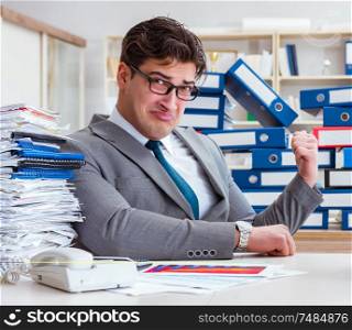 The businessman busy with much paperwork. Businessman busy with much paperwork
