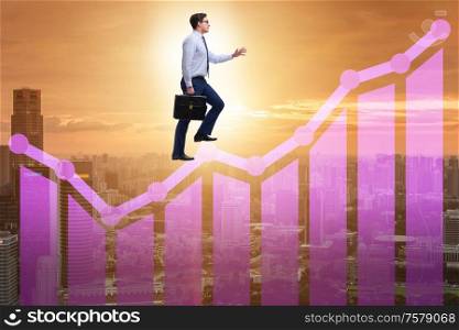 The businessman climbing bar charts in growth concept. Businessman climbing bar charts in growth concept