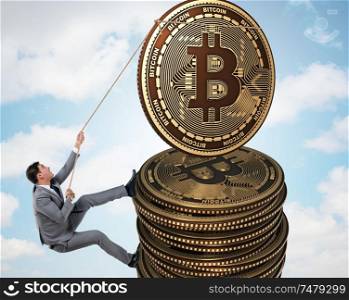 The businessman climbing the stack of bitcoins. Businessman climbing the stack of bitcoins