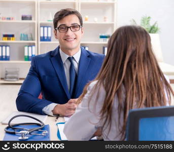 The businessman discussing health issues with doctor. Businessman discussing health issues with doctor