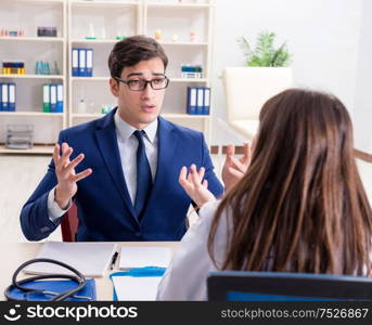 The businessman discussing health issues with doctor. Businessman discussing health issues with doctor