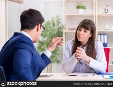 The businessman discussing health issues with doctor. Businessman discussing health issues with doctor