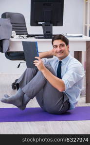 The businessman doing sports in office during break. Businessman doing sports in office during break