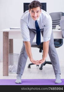 The businessman doing sports in office during break. Businessman doing sports in office during break