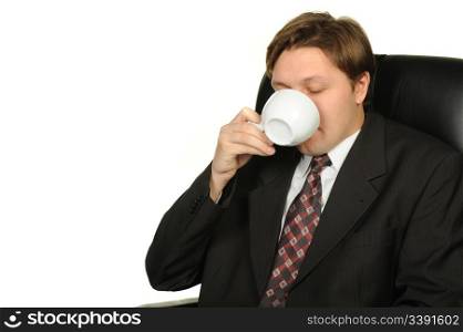 The businessman drinking coffee. It is isolated on a white background