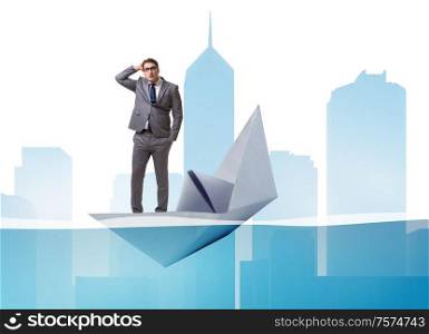 The businessman escaping sunken paper boat ship. Businessman escaping sunken paper boat ship
