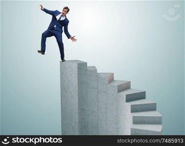 The businessman falling from high block in failure concept. Businessman falling from high block in failure concept