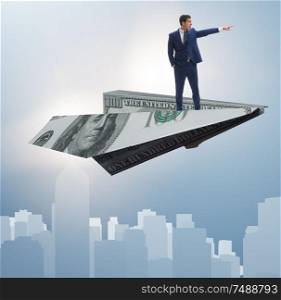 The businessman flying on paper plane in business concept. Businessman flying on paper plane in business concept