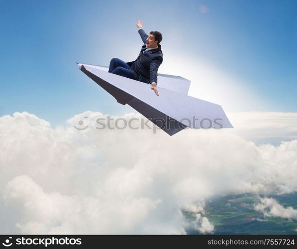 The businessman flying on paper plane in business concept. Businessman flying on paper plane in business concept