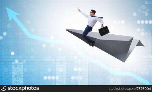 The businessman flying on paper plane in business concept. Businessman flying on paper plane in business concept
