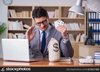 The businessman gambling playing cards at work. Businessman gambling playing cards at work