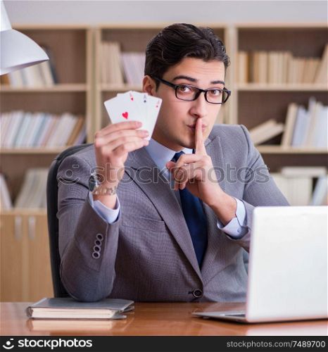 The businessman gambling playing cards at work. Businessman gambling playing cards at work