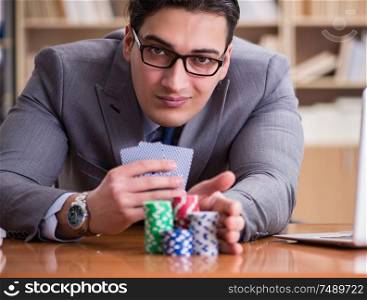 The businessman gambling playing cards at work. Businessman gambling playing cards at work