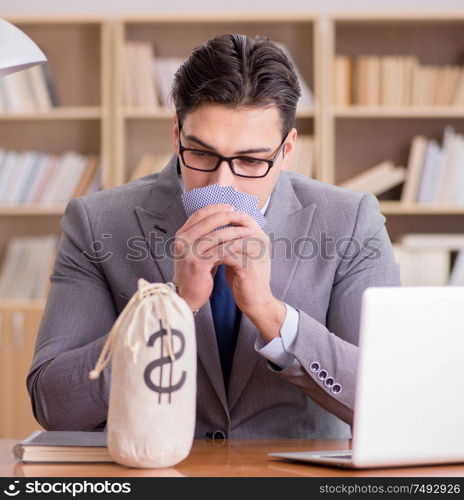 The businessman gambling playing cards at work. Businessman gambling playing cards at work