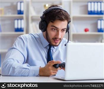 The businessman gamer in office playing games. Businessman gamer in office playing games