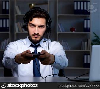 The businessman gamer staying late to play games. Businessman gamer staying late to play games