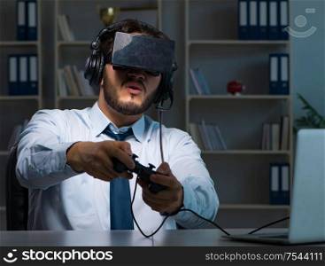 The businessman gamer staying late to play games. Businessman gamer staying late to play games