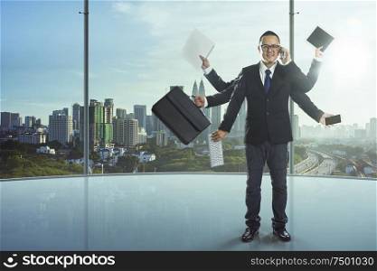 The businessman has a lot of hands to complete his work, a powerful businessman concept.
