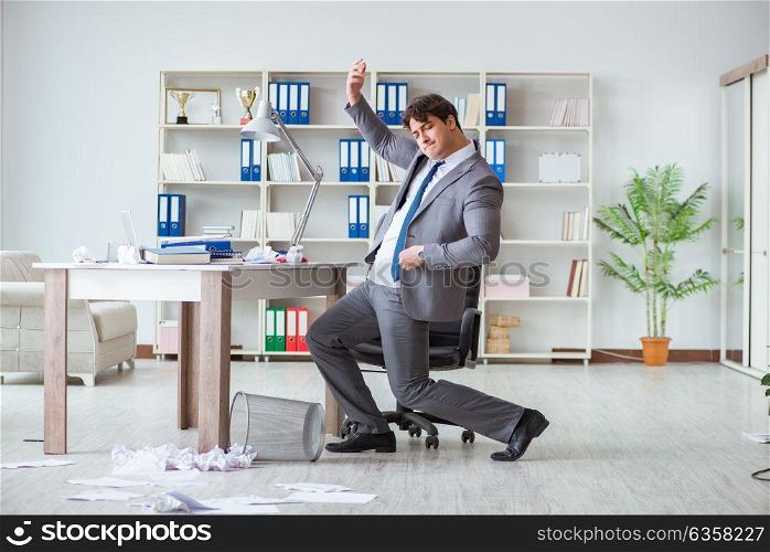The businessman having fun taking a break in the office at work. Businessman having fun taking a break in the office at work
