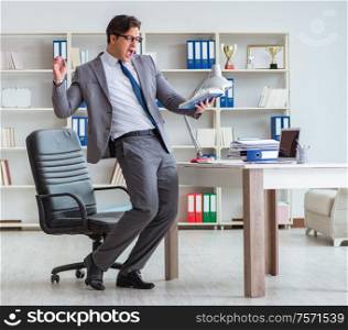 The businessman having fun taking a break in the office at work. Businessman having fun taking a break in the office at work