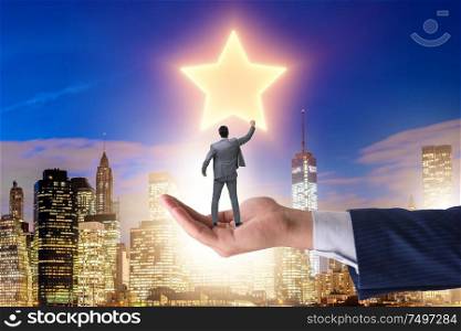 The businessman held on hand reaching out for stars. Businessman held on hand reaching out for stars