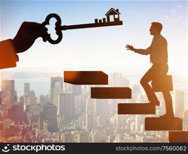 The businessman holding key in real estate concept. Businessman holding key in real estate concept