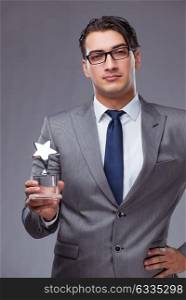 The businessman holding star award in business concept. Businessman holding star award in business concept
