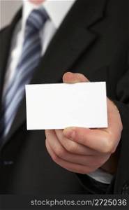 The businessman in a suit and a tie. Hand with a white card.