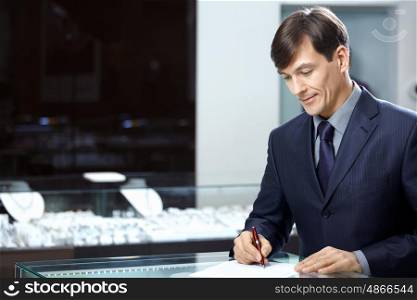 The businessman in a suit signs papers