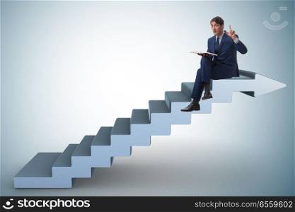The businessman in career ladder concept reading book. Businessman in career ladder concept reading book. The businessman in career ladder concept reading book