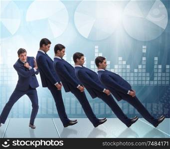 The businessman in domino effect business concept. Businessman in domino effect business concept