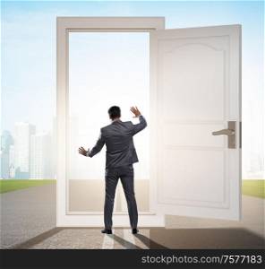 The businessman in front of door in business opportunities concept. Businessman in front of door in business opportunities concept
