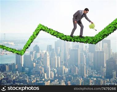 The businessman in investment concept watering financial line chart. Businessman in investment concept watering financial line chart