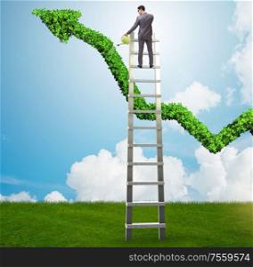 The businessman in investment concept watering financial line chart. Businessman in investment concept watering financial line chart