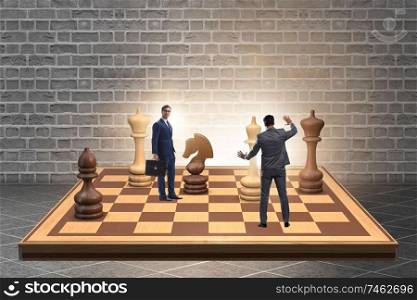 The businessman in large chess board in strategy concept. Businessman in large chess board in strategy concept