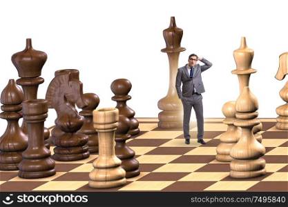 The businessman in large chess board in strategy concept. Businessman in large chess board in strategy concept