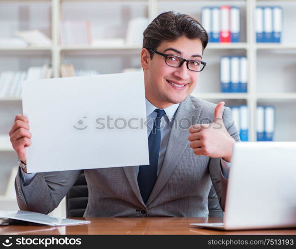 The businessman in office holding a blank message board. Businessman in office holding a blank message board