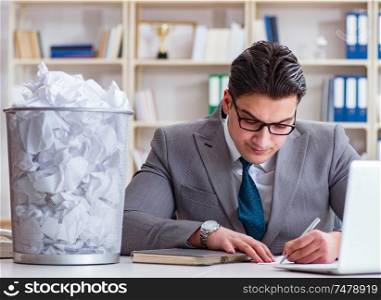 The businessman in paper recycling concept in office. Businessman in paper recycling concept in office