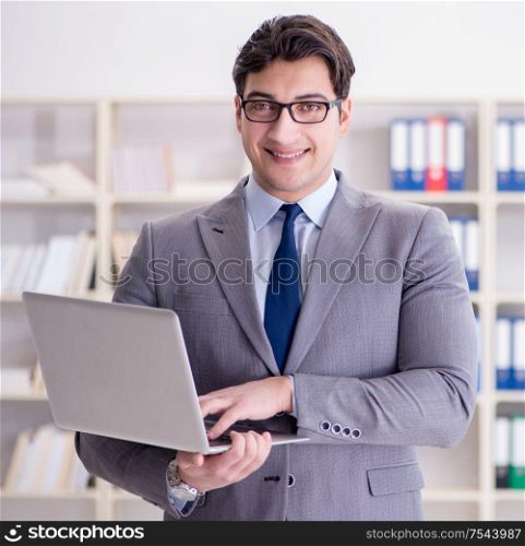 The businessman in the office working with laptop. Businessman in the office working with laptop