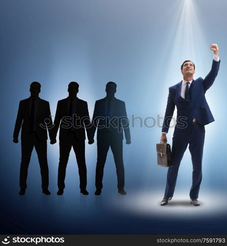 The businessman in the spotlight in business concept. Businessman in the spotlight in business concept