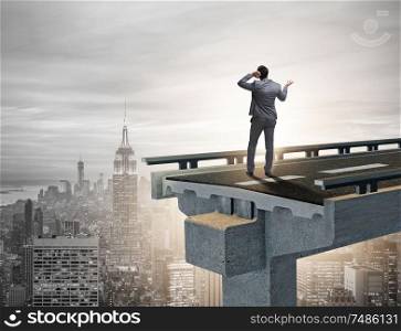 The businessman in uncertainty concept with broken bridge. Businessman in uncertainty concept with broken bridge