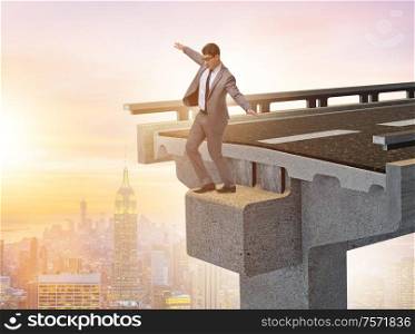 The businessman in uncertainty concept with broken bridge. Businessman in uncertainty concept with broken bridge