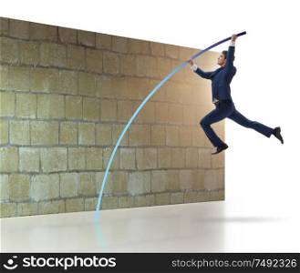 The businessman jumping over brickwall in business concept. Businessman jumping over brickwall in business concept