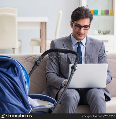 The businessman looking after newborn baby at home and teleworking. Businessman looking after newborn baby at home and teleworking