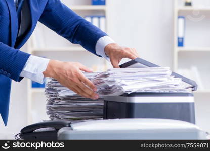 The businessman making copies in copying machine. Businessman making copies in copying machine