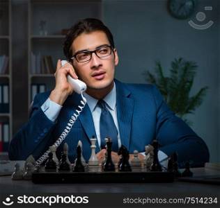 The businessman playing chess in strategy concept. Businessman playing chess in strategy concept