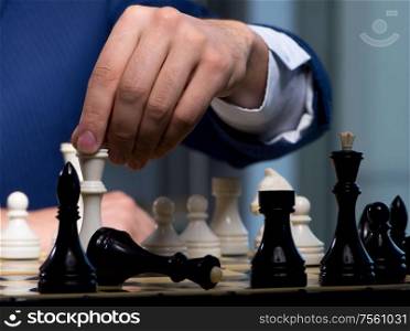 The businessman playing chess in strategy concept. Businessman playing chess in strategy concept
