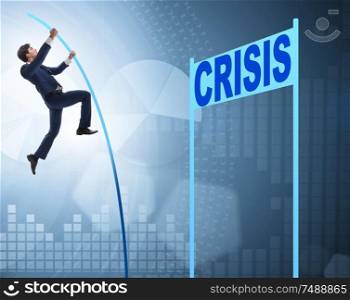 The businessman pole vaulting over crisis in business concept. Businessman pole vaulting over crisis in business concept