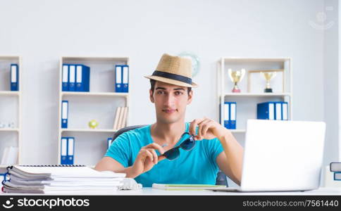 The businessman preparing for vacation in the office. Businessman preparing for vacation in the office