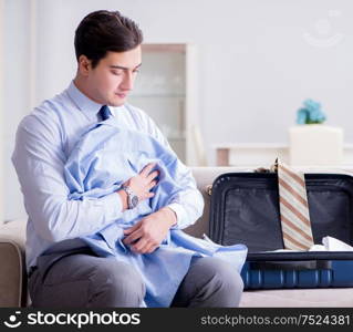 The businessman preparing packing for business trip. Businessman preparing packing for business trip